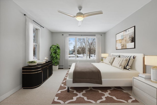 carpeted bedroom featuring ceiling fan and baseboard heating