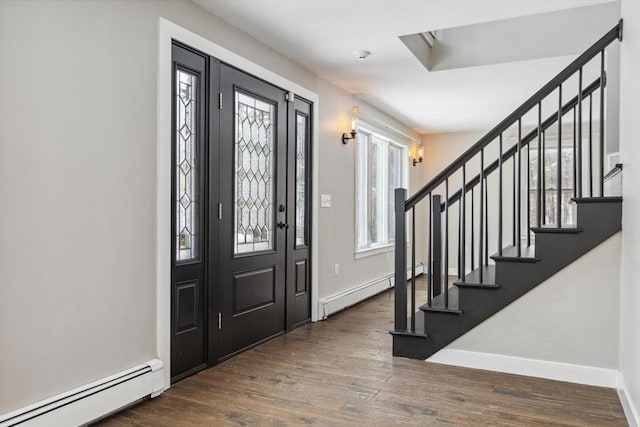 entryway featuring baseboard heating, dark hardwood / wood-style flooring, and a wealth of natural light