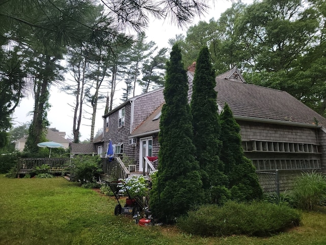 view of property exterior with a lawn