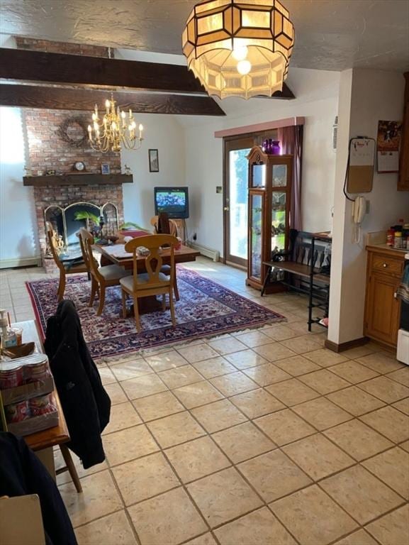 51 Nye Ln, Bourne, MA 02532 - dining space with light tile patterned floors, a chandelier, a fireplace, and baseboards