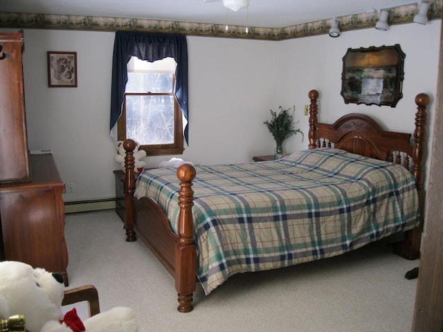 carpeted bedroom with a baseboard heating unit