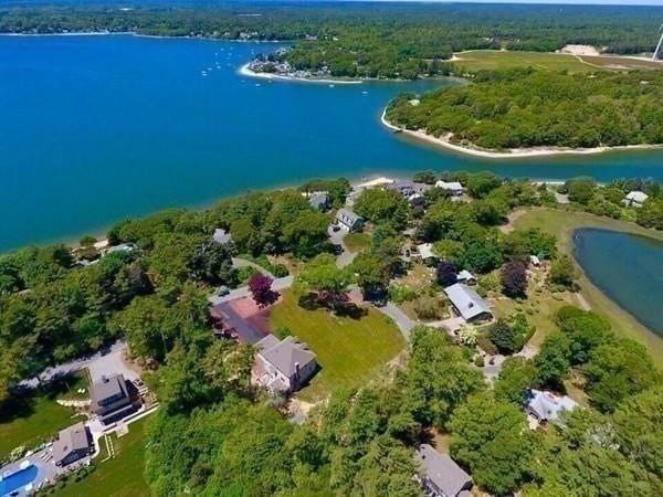 birds eye view of property with a water view and a forest view