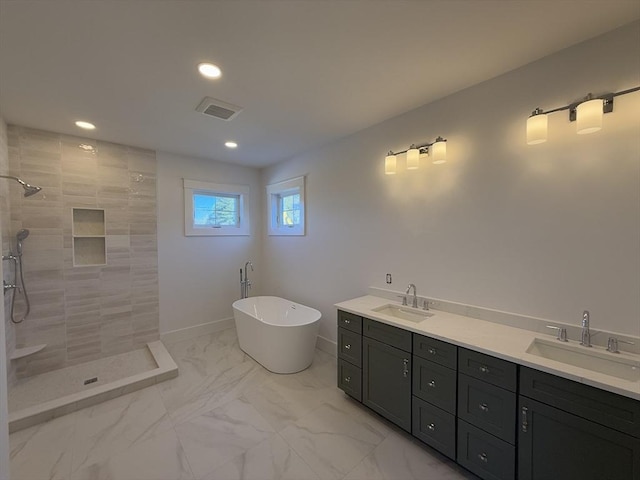 bathroom with vanity and independent shower and bath