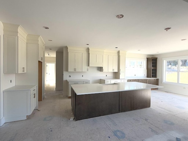 kitchen with wall oven, white cabinets, and a large island