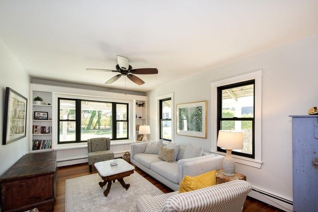 living room featuring a baseboard radiator, dark wood-style flooring, and a ceiling fan