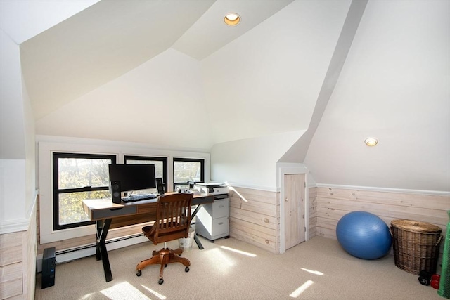 home office with vaulted ceiling, carpet, a baseboard radiator, wood walls, and a wainscoted wall