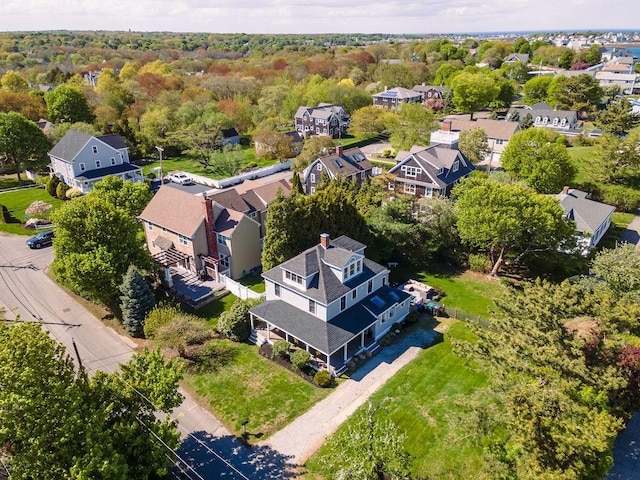 aerial view of residential area featuring a forest