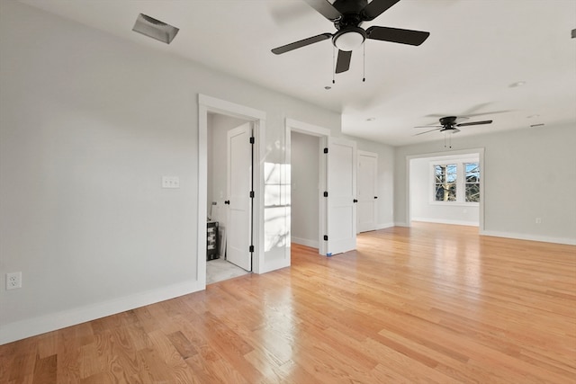 spare room with ceiling fan and light wood-type flooring