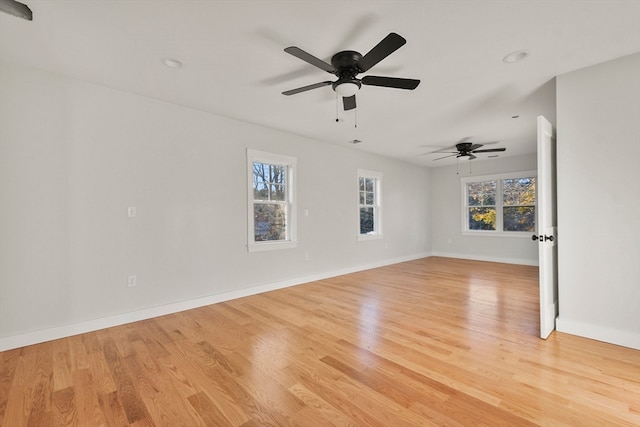 empty room featuring ceiling fan and light wood-type flooring