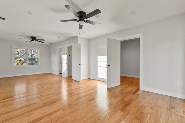 spare room with ceiling fan and light wood-type flooring