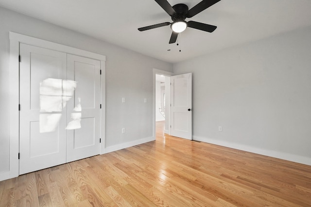 unfurnished bedroom with ceiling fan, a closet, and light hardwood / wood-style floors