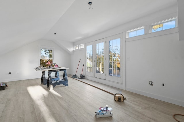 interior space with lofted ceiling and light wood-type flooring