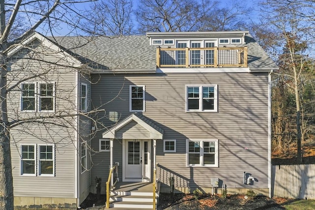 view of front of home featuring a balcony