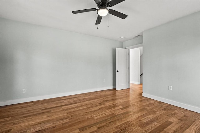 unfurnished room with hardwood / wood-style floors and ceiling fan