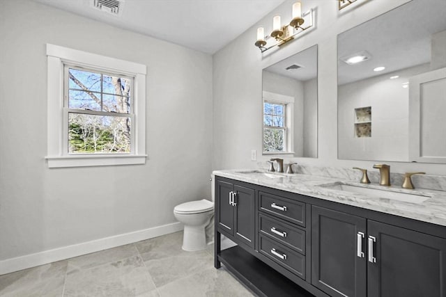 bathroom with tile patterned flooring, vanity, and toilet