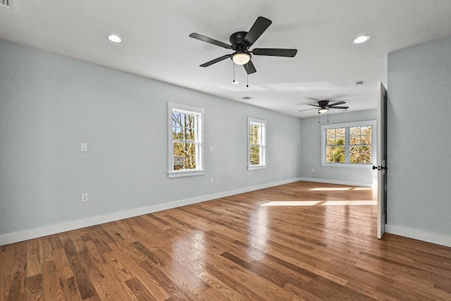 empty room with hardwood / wood-style flooring and ceiling fan