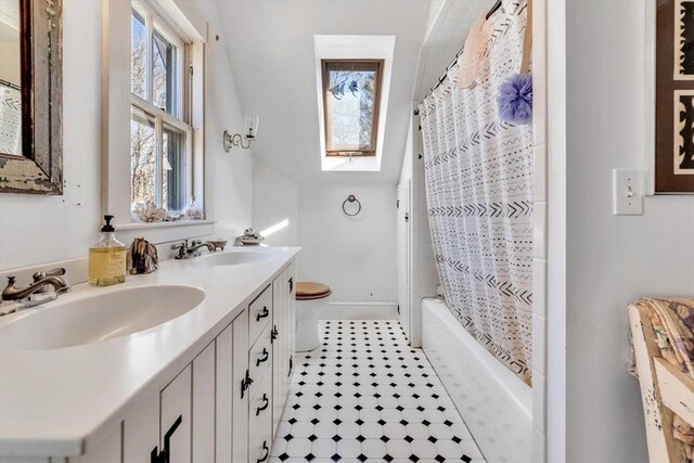 2241 Main St, Brewster, MA 02631 - bathroom with toilet, double vanity, shower / tub combo, and baseboards