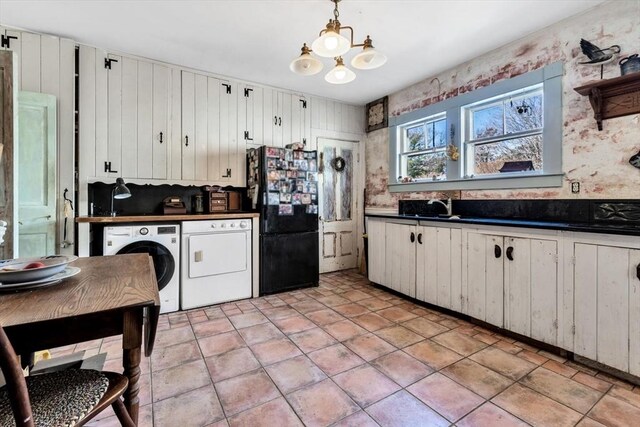 2241 Main St, Brewster, MA 02631 - kitchen featuring washer / clothes dryer, freestanding refrigerator, dark countertops, and a chandelier
