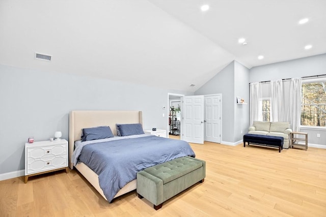 bedroom with lofted ceiling and hardwood / wood-style floors