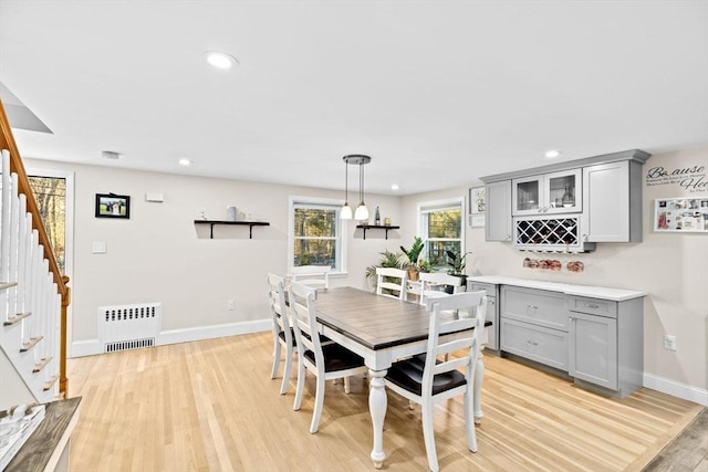 dining room with radiator and light hardwood / wood-style flooring