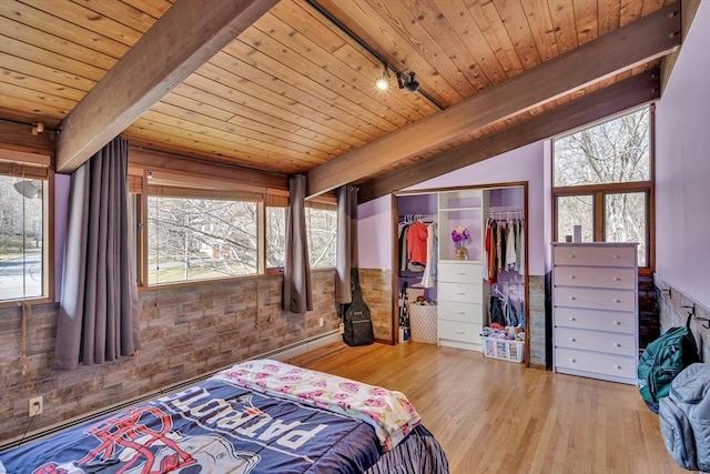 bedroom with wood ceiling, wood finished floors, and multiple windows