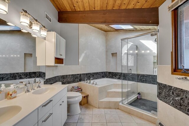 bathroom with a stall shower, a garden tub, visible vents, and tile patterned flooring