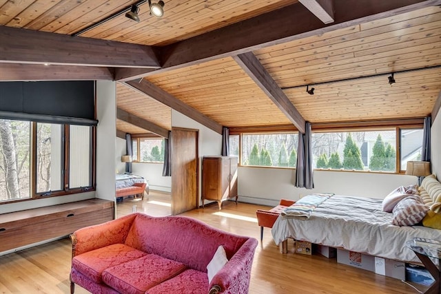 bedroom featuring vaulted ceiling with beams, rail lighting, multiple windows, and wood ceiling