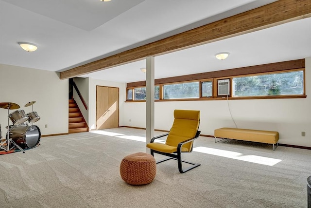living area with baseboards, stairs, and carpet
