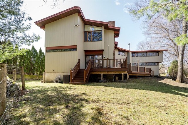 rear view of house featuring a deck, stairway, central AC, and a lawn
