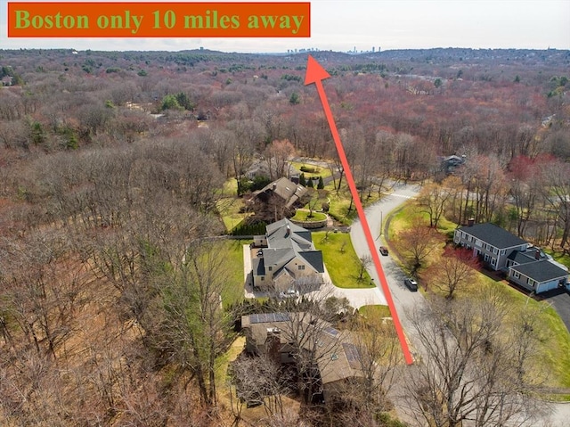 birds eye view of property featuring a wooded view