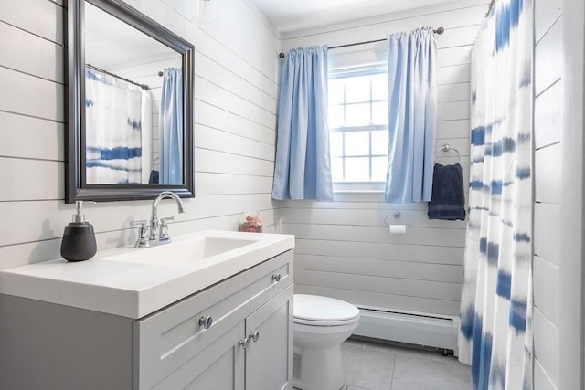 bathroom with wood walls, a baseboard radiator, tile patterned flooring, vanity, and toilet