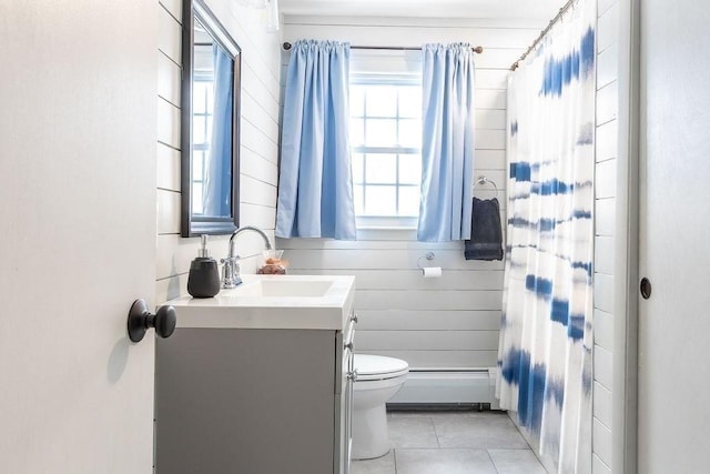 bathroom featuring a baseboard radiator, a healthy amount of sunlight, vanity, and toilet