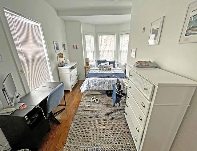 bedroom with dark wood-style flooring
