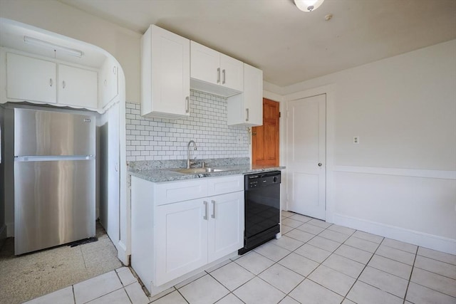18-20 Melbourne Ave, Newton, MA 02460 - kitchen featuring freestanding refrigerator, black dishwasher, tasteful backsplash, light tile patterned floors, and white cabinets