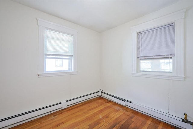 18-20 Melbourne Ave, Newton, MA 02460 - spare room with light wood-style floors and a baseboard heating unit