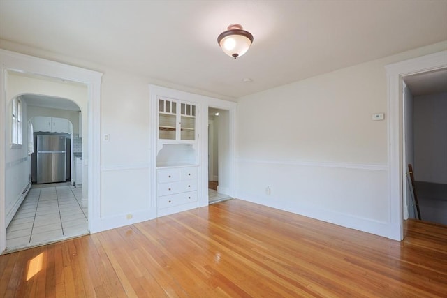 18-20 Melbourne Ave, Newton, MA 02460 - empty room with wood-type flooring and arched walkways