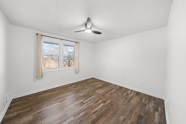 unfurnished room with ceiling fan and dark hardwood / wood-style floors