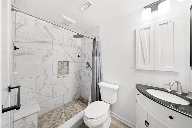 bathroom with toilet, vanity, and curtained shower