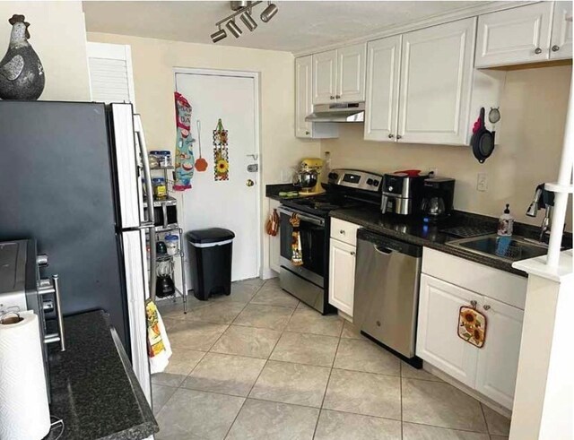 333 Main St, Melrose, MA 02176 - kitchen with stainless steel appliances, under cabinet range hood, a sink, and white cabinets