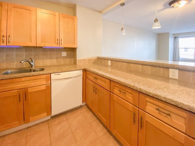 kitchen featuring dishwasher, pendant lighting, decorative backsplash, light tile patterned flooring, and a sink