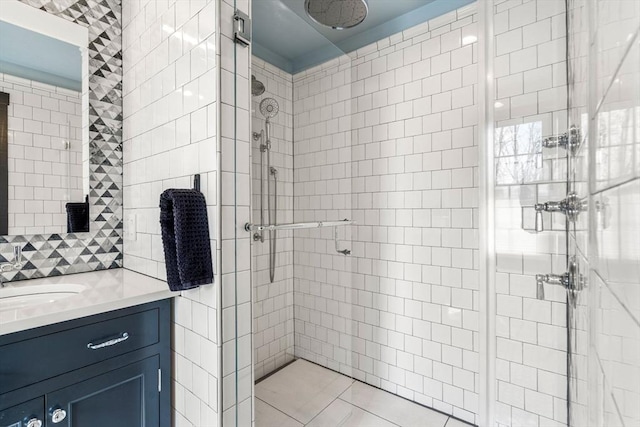 full bathroom featuring a stall shower, vanity, and tile walls