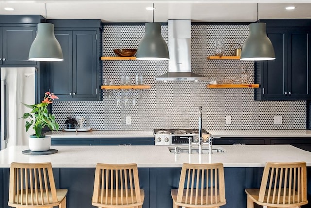 kitchen featuring open shelves, wall chimney exhaust hood, and light countertops