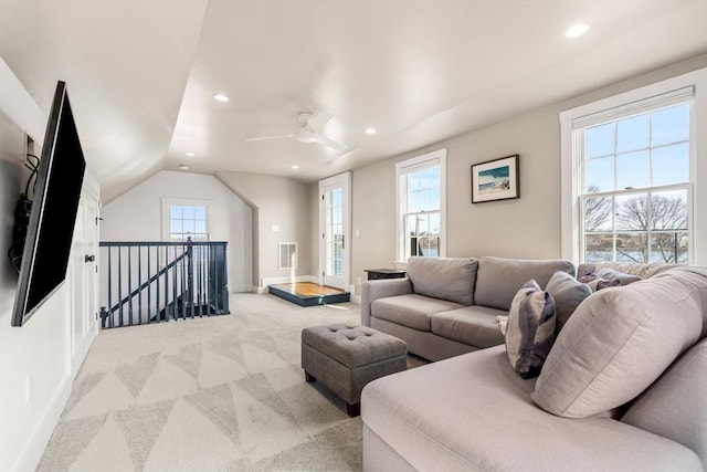 living room featuring recessed lighting, light colored carpet, visible vents, vaulted ceiling, and baseboards