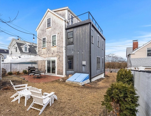 back of house featuring a patio area and a fenced backyard