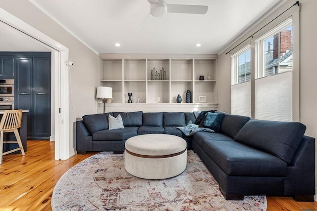 living area featuring a ceiling fan, recessed lighting, and light wood finished floors