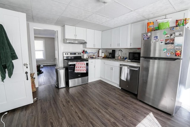 kitchen featuring a sink, under cabinet range hood, white cabinets, stainless steel appliances, and dark wood-style flooring