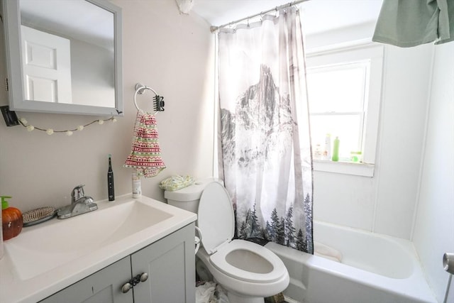 full bath featuring shower / bath combo with shower curtain, toilet, and vanity