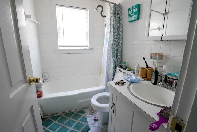 bathroom with vanity, tile walls, shower / tub combo, and toilet