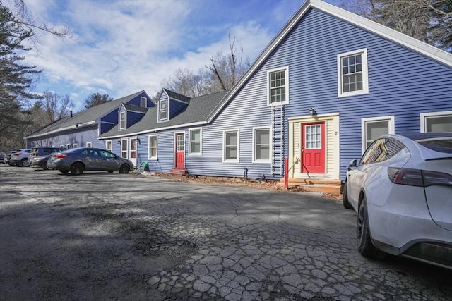 view of front of property with uncovered parking and entry steps