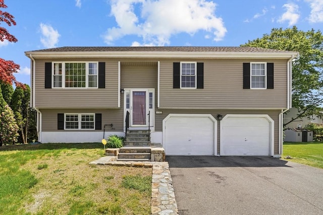447 Old Connecticut Path, Framingham, MA 01701 - split foyer home featuring an attached garage, asphalt driveway, and a front lawn